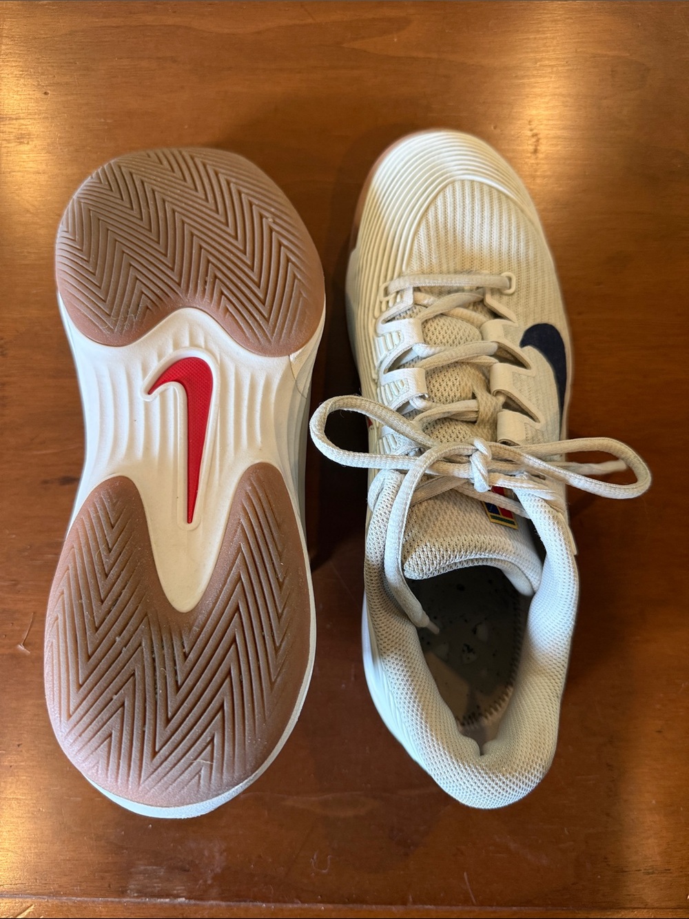 Nike White Sneakers with Navy Swoosh and Red Sole Accent